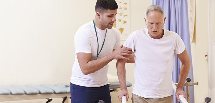 rehab therapist with a resident in the rehab gym