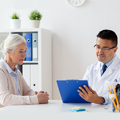 A doctor and a patient looking at a patient chart together.