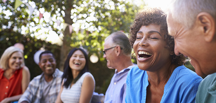 A group of people outside laughing together.