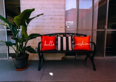 A bench next to a plant in the courtyard of Glendale Healthcare Center
