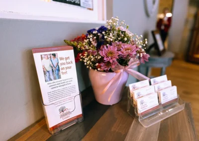 A bouquet of flowers next to business cards at Glendale Healthcare Center
