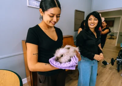 A caretaker holding a bunny at Glendale Healthcare Center
