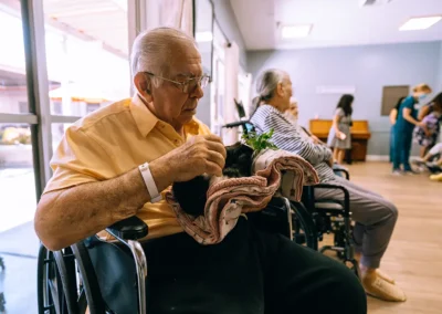 An elderly man holding a bunny Glendale Healthcare Center