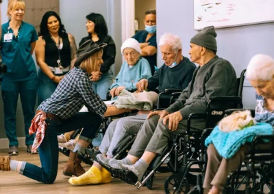 A group of residents looking at a guinea pig at Glendale Healthcare Center