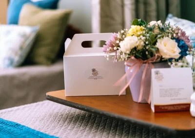 A package and flowers by a resident's bed at Glendale Healthcare Center