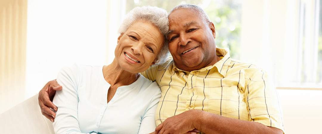 A smiling, happy African American couple at home