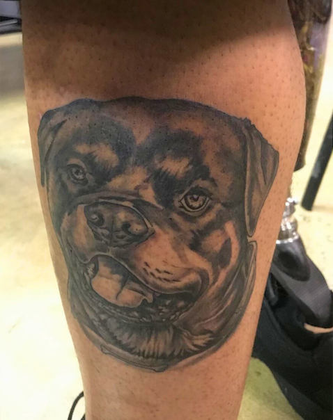 Tattoo of dog on back of leg