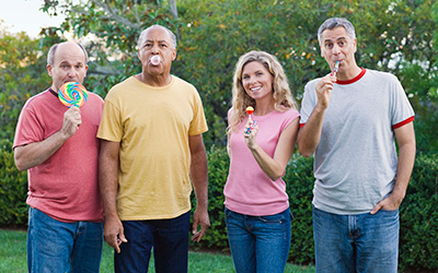 Four adults eating candy