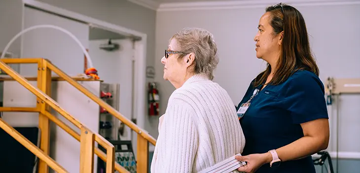 An elderly woman doing therapy with a PT at Valley Palms