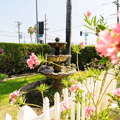 A fountian and flowers outside of Valley Palms