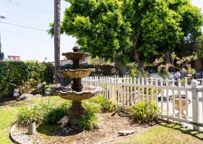 A fountain next to a fence at Valley Palms