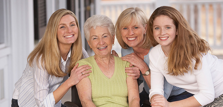 A family outside smiling.