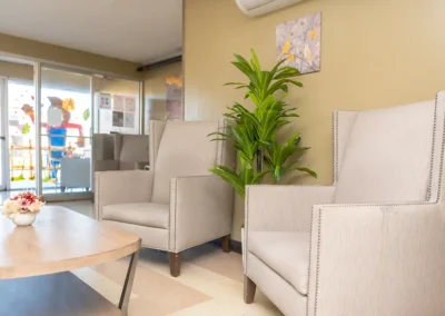 Two chairs and a plant in the lobby of Hickory Village