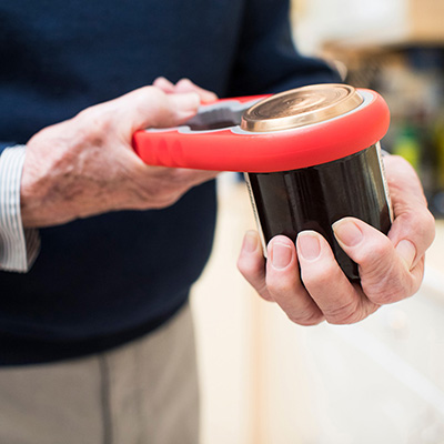 elderly man opening a jar