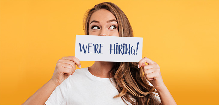 yolo-730x350-129 woman holding a "we're hiring" sign