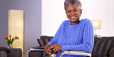 yolo-730x350-109 A senior smiling in her wheelchair.