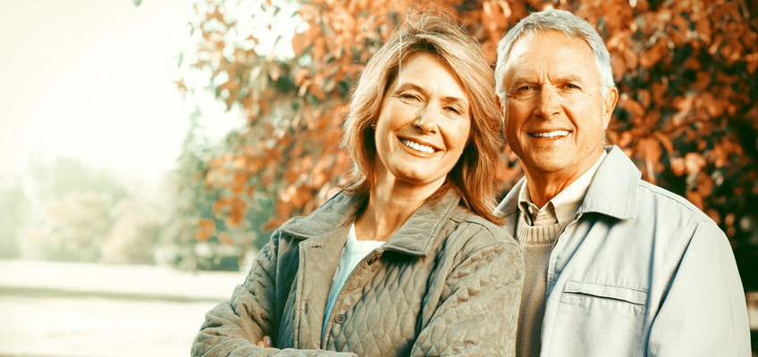 Elderly couple outside smiling