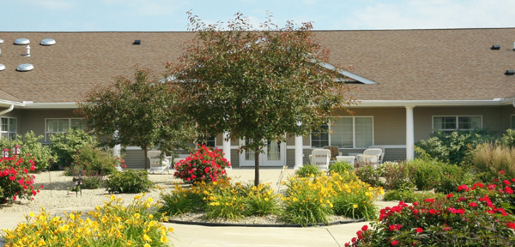 Outside seating area surrounded by flowers in a garden