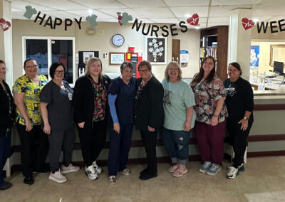 A group of nurses smiling together at Farmington Village