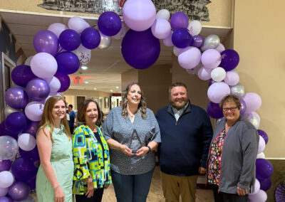 A group of employees at an award night at Farmington Village