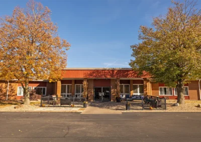 Front entrance of the Farmington Village Nursing and Rehabilitation Center with trees
