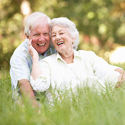 Residents sitting in the grass.