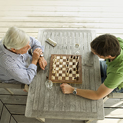 Two men playing chess together at a table.