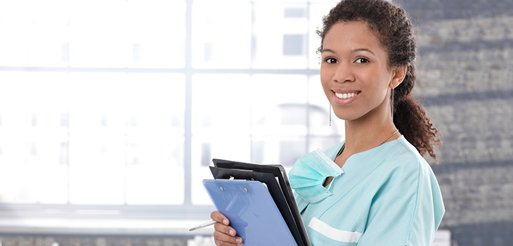 smiling nurse holding a clipboard