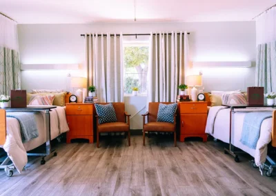 Two beds in a room with chairs and desks at Mountain View